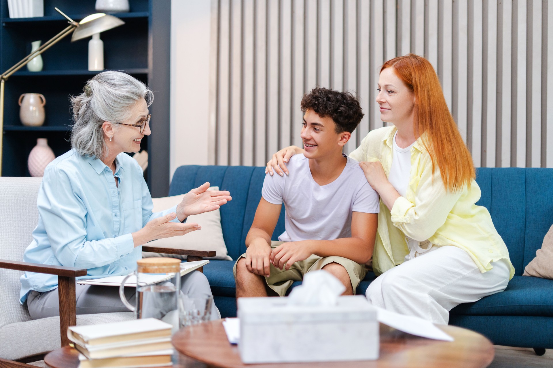 Family seeking advice from psychotherapist sitting on sofa